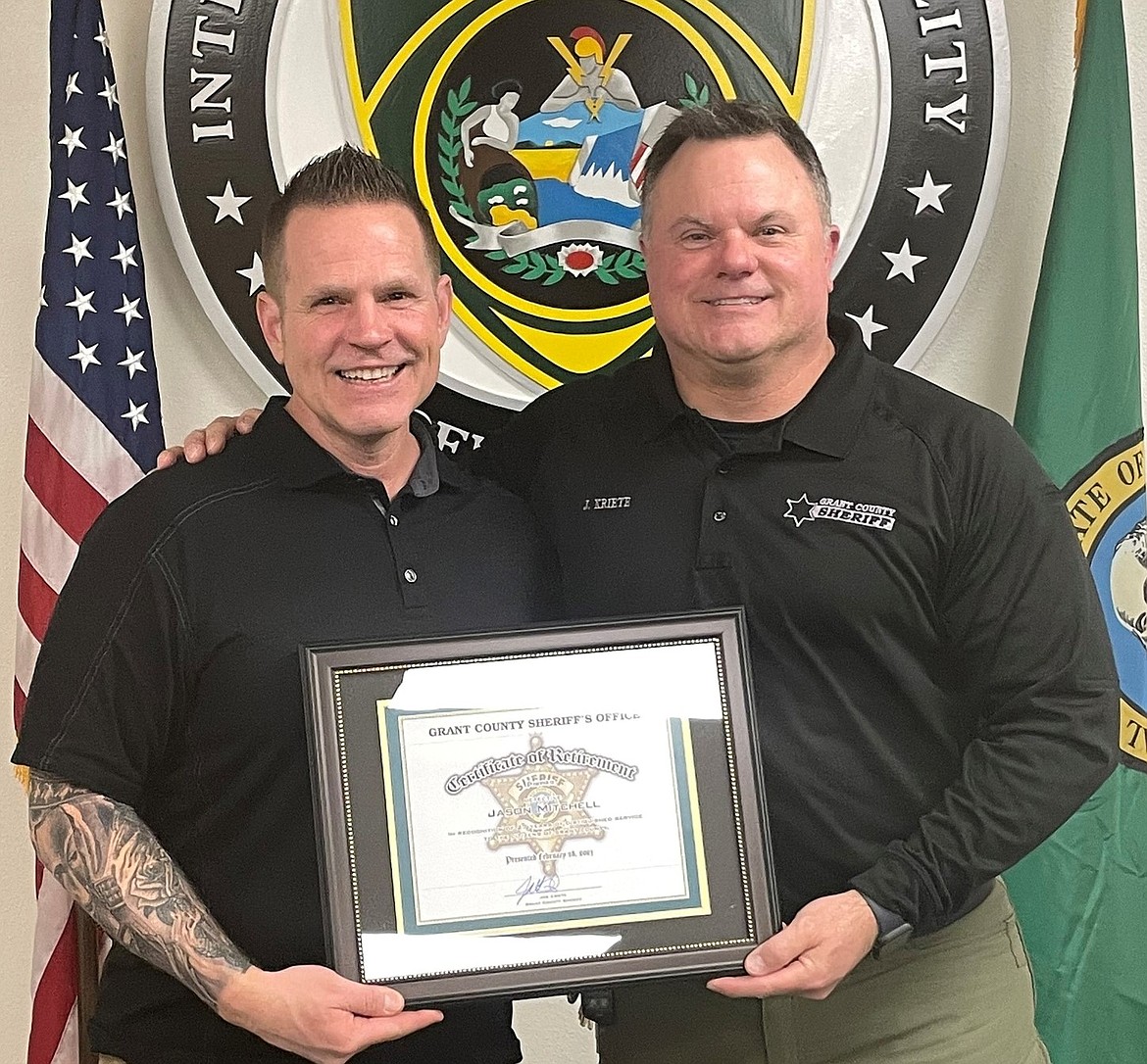 Grant County Sheriff Joe Kriete presents Detective Jason Mitchell with a retirement plaque on Feb. 28. Mitchell retired after nearly three decades in law enforcement.