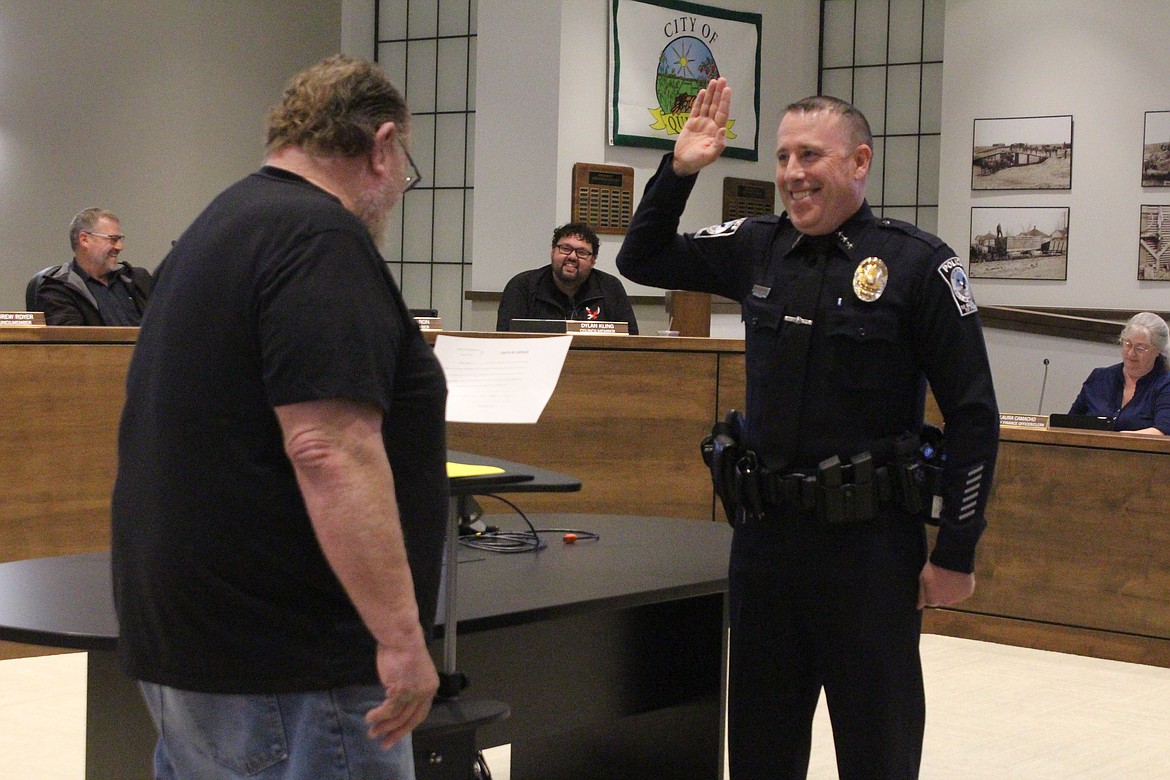 Ryan Green, right, is sworn in as the new Quincy Police Chief by Quincy Mayor Paul Worley, left, at the Quincy City Council meeting Tuesday.