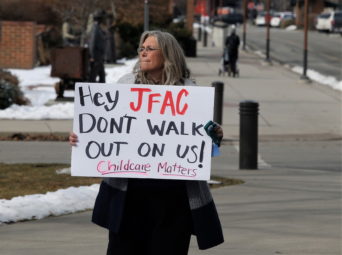 Tana Vanderholm, president of Storybook Early Learning Centers, holds a sign during a child care rally near Coeur d'Alene City Hall on Wednesday.