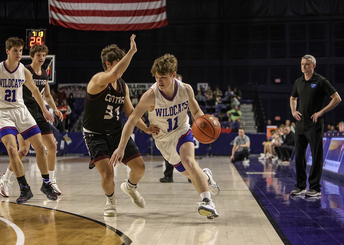 Columbia Falls junior Mark Robison dribbles past a Butte Central player on Thursday, March 9, at the State A Boys Basketball Tournament in Bozeman. (JP Edge/Hungry Horse News)