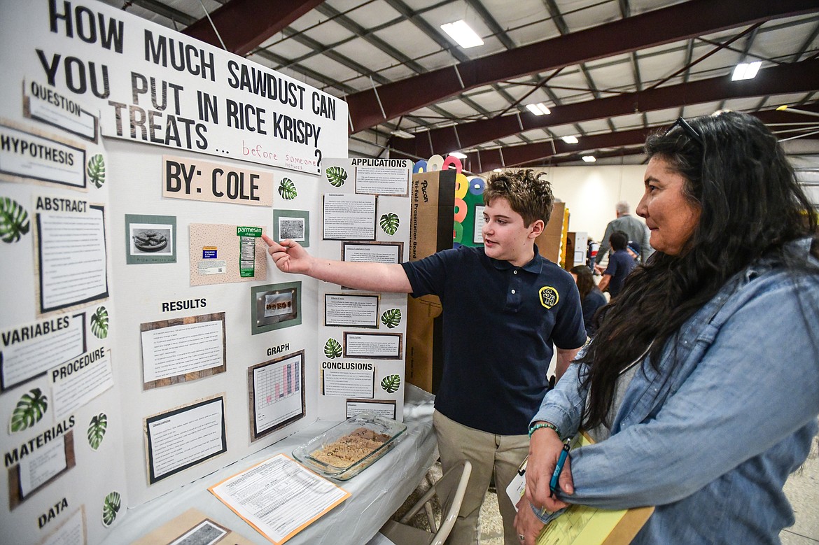 Cole Schettler, a sixth-grader at St. Matthew's School, discusses his project titled "How Much Sawdust Can You Put in Rice Krispy Treats ... Before Someone Notices?" with judge Victoria Gabaldon at the Flathead County Science Fair at the Flathead County Fairgrounds Expo Building on Thursday, March 9. (Casey Kreider/Daily Inter Lake)