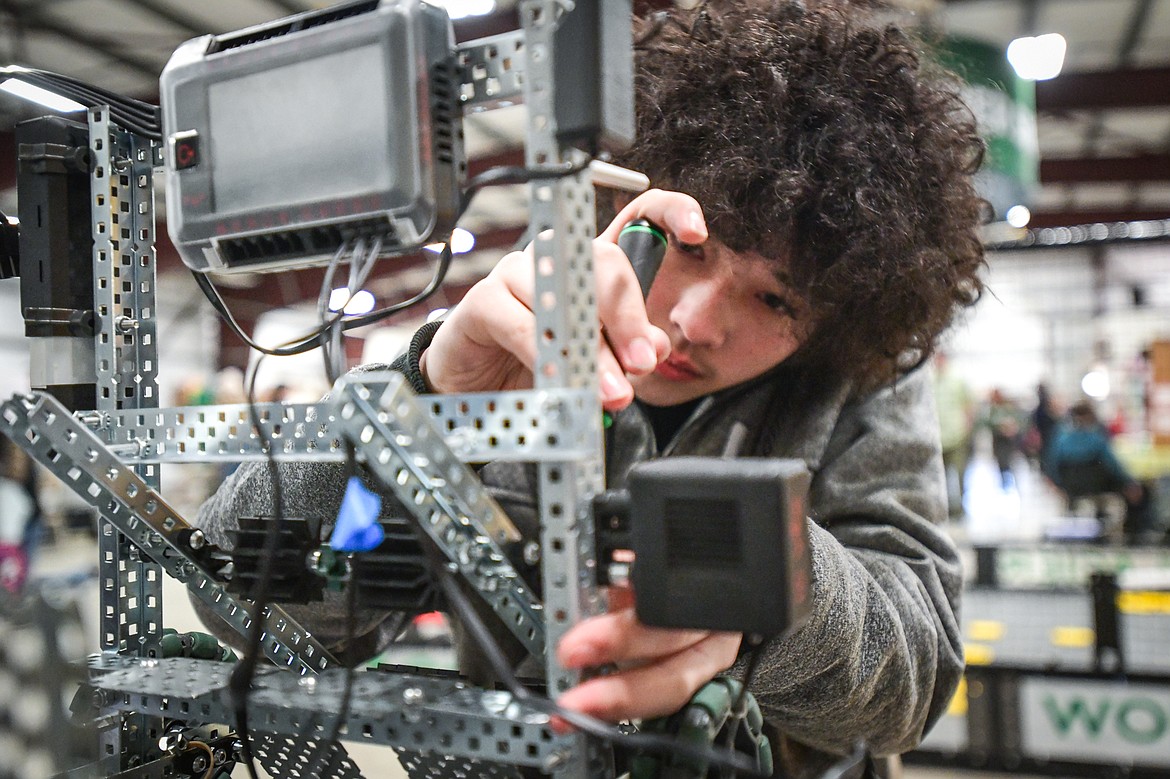 Judah Wong, a sophomore in Glacier High School's Technology Student Association, makes adjustments to his disc-flipping robot at the Flathead County Science Fair at the Flathead County Fairgrounds Expo Building on Thursday, March 9. (Casey Kreider/Daily Inter Lake)