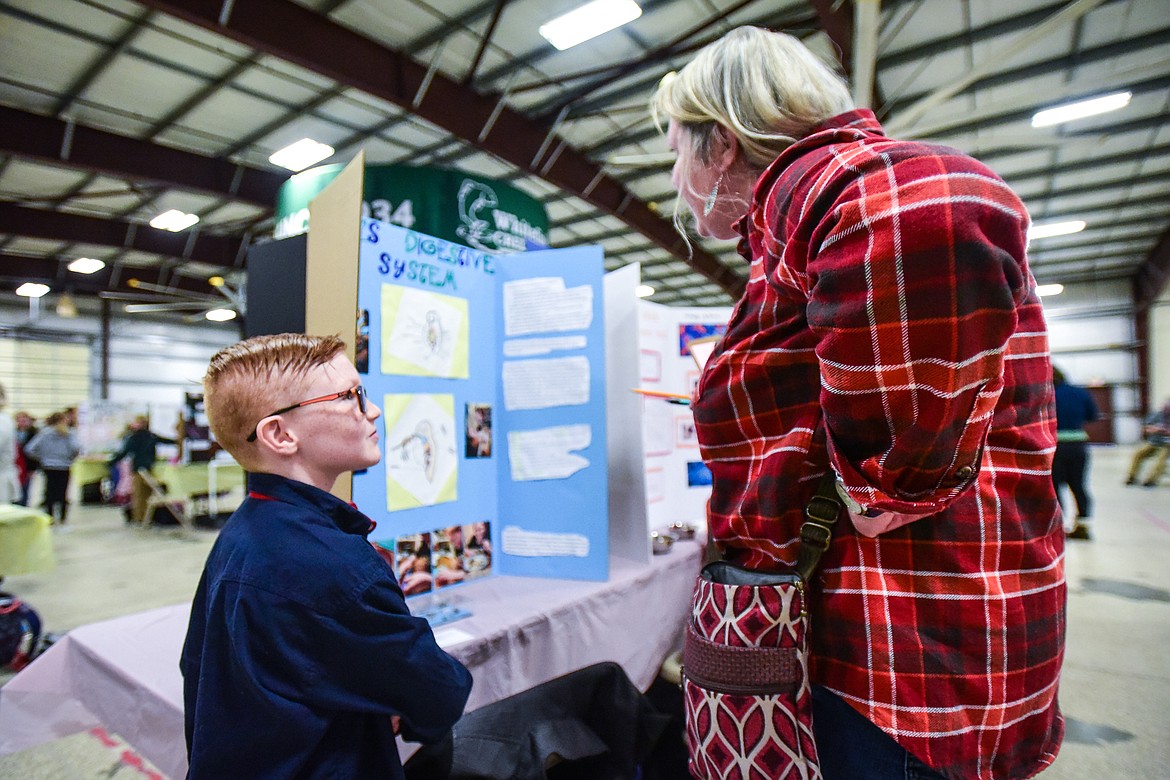 Hunter Keller, a third-grader at Edgerton Elementary School, discusses his project titled "Owl's Digestive System" to judge Jessie Walthers at the Flathead County Science Fair at the Flathead County Fairgrounds Expo Building on Thursday, March 9. (Casey Kreider/Daily Inter Lake)