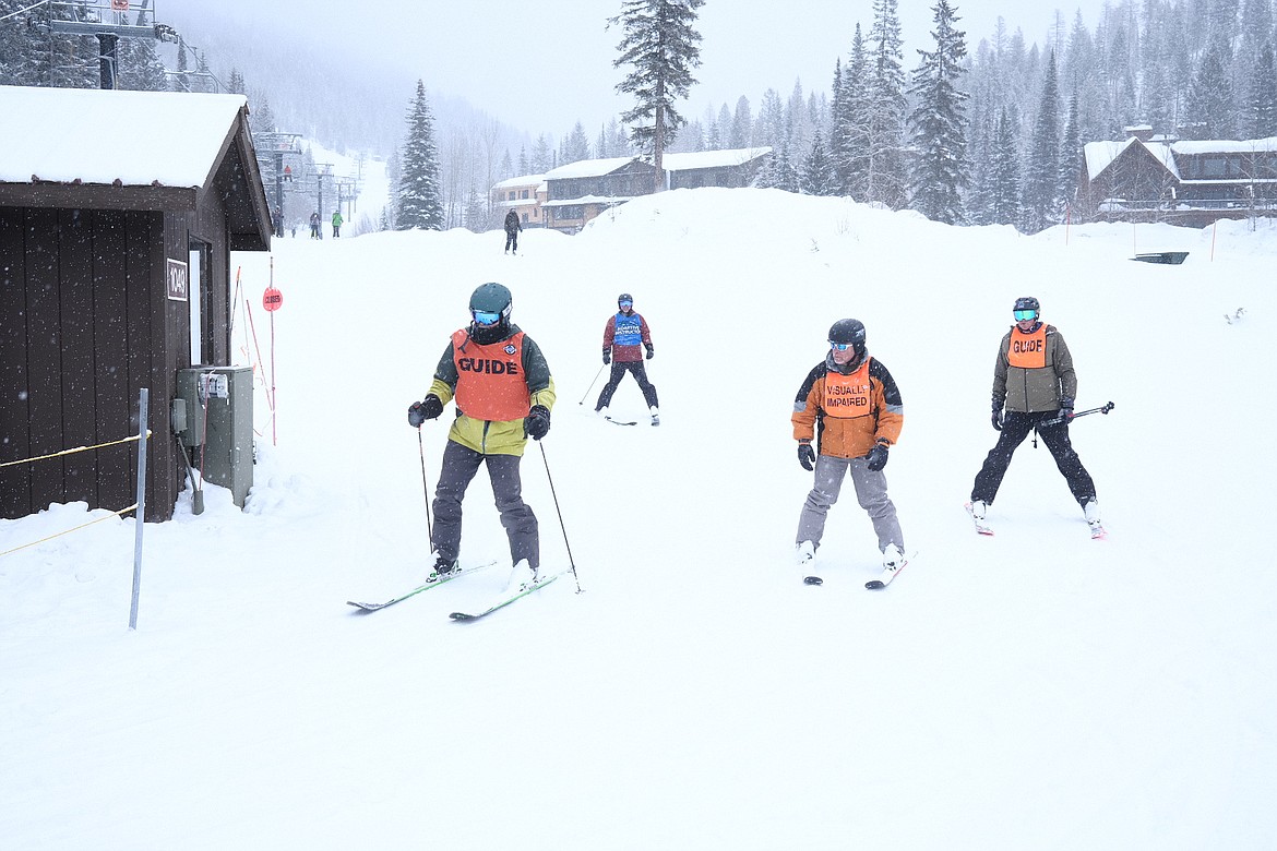Veteran Danny Wallace and his team of volunteers prepare for another ride up the chairlift at Whitefish Mountain Resort on Tuesday, Feb. 28, 2023. (Adrian Knowler/Daily Inter Lake)