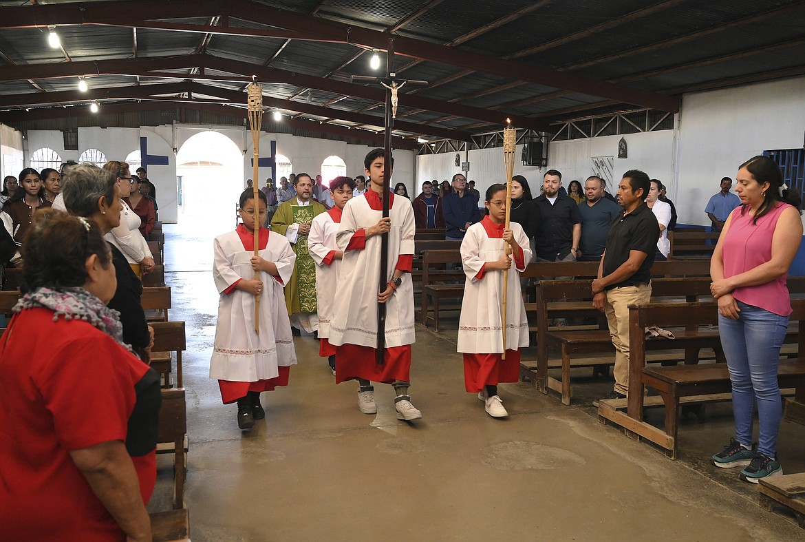 Altar servers lead the opening processional at the Immaculate Conception of Maria, La Carpio, Catholic church where the majority of the congregation is made up of Nicaraguan exiles and refugees, in San Jose, Costa Rica, Sunday, Feb. 19, 2023. Dozens of priests, nuns, seminarians and church workers have fled Nicaragua in recent years, or been exiled by President Daniel Ortega’s government, which considers them a threat. (AP Photo/Carlos Gonzalez)