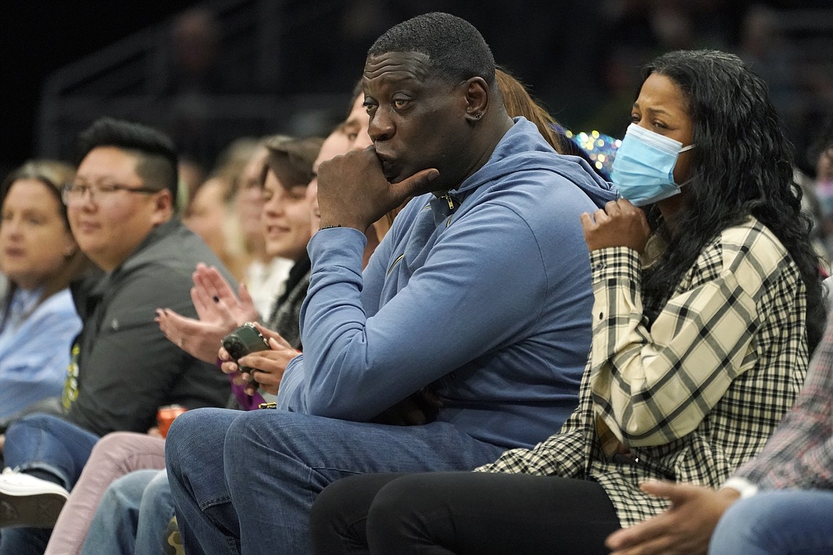 Former Seattle SuperSonics forward Shawn Kemp, center, attends a WNBA basketball game between the Seattle Storm and the Chicago Sky, Wednesday, May 18, 2022 in Seattle. Shawn Kemp was arrested and charged in connection with a drive-by shooting in Tacoma, Washington, and was set to be appear in court Thursday, March 9, 2023, a sheriff's official said. Online jail records show Kemp was booked on a felony charge of drive-by shooting shortly before 6 p.m. Wednesday. (AP Photo/Ted S. Warren, File)