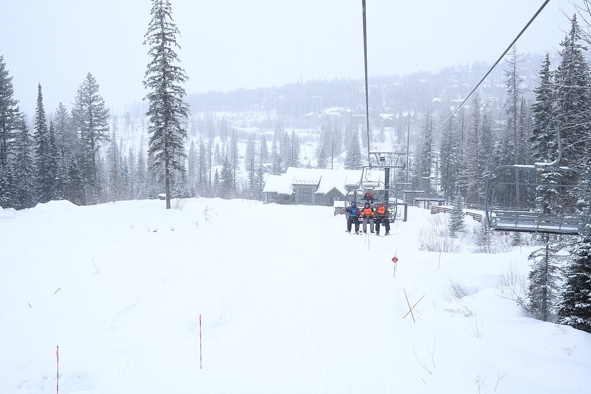 Army veteran Danny Wallace rides up Chairlift 9 with his team of adaptive ski volunteers at Whitefish Mountain Resort on Tuesday, Feb. 28, 2023. (Adrian Knowler/Daily Inter Lake)