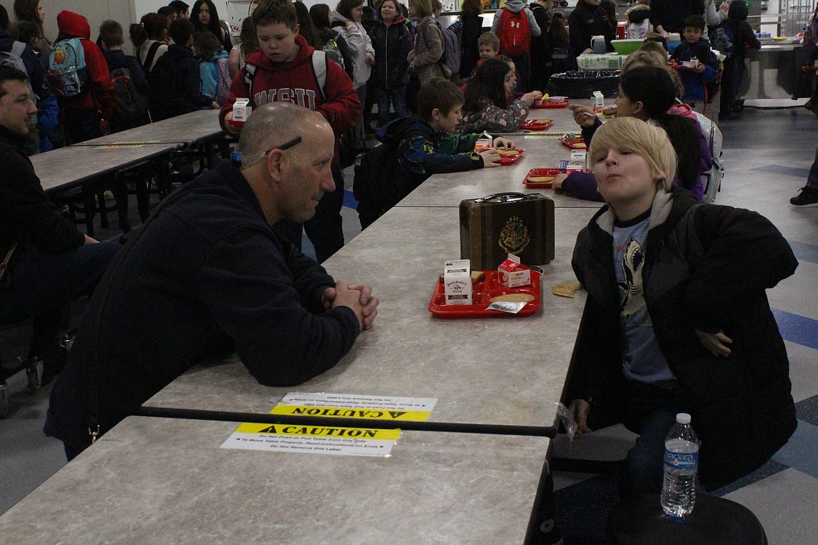 Brandon Burns of the Moses Lake Fire Department talks with a Groff Elementary breakfast buddy during the first responder visit Wednesday.