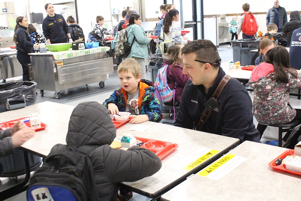 Garrett Fletcher of the Moses Lake Fire Department talks with Groff Elementary students during a breakfast visit by first responders.