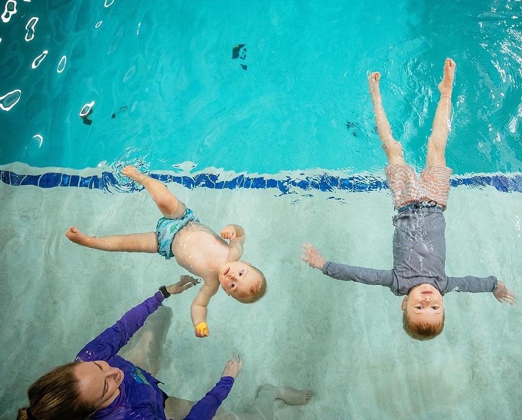 Rachel Jessup, founder of Field to Forest childcare and Glacier ISR swim program, works with students and brothers, Ledger and Magnus Ray practicing their safety floats. (Courtesy photo)