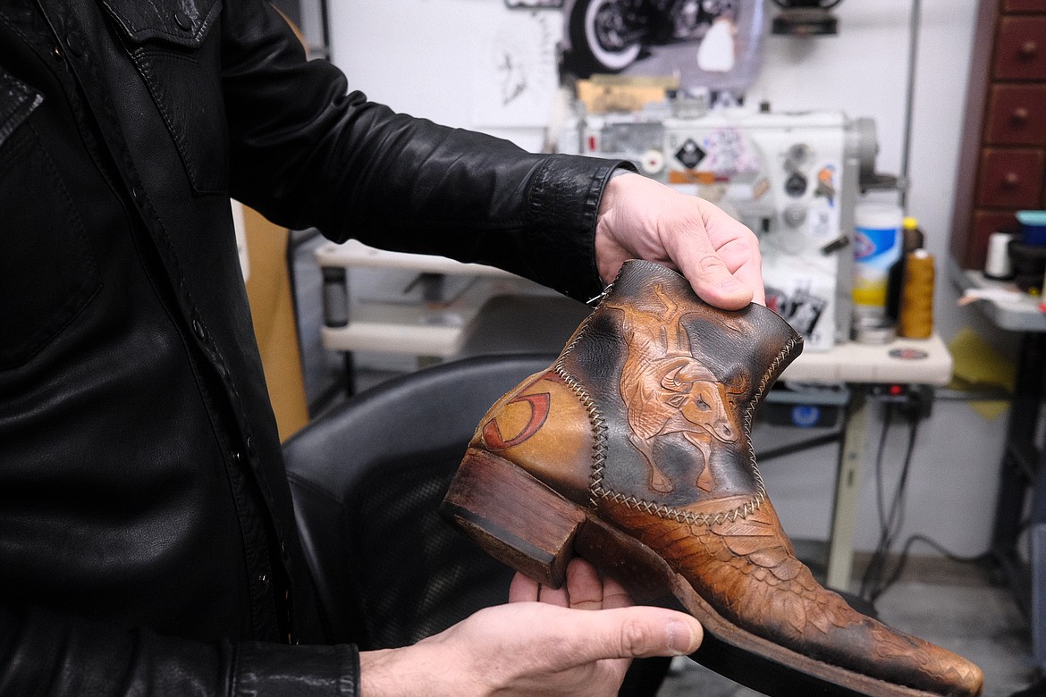 Milen Krastev shows off some recent handiwork, a custom pair of leather boots. (Adrian Knowler/Daily Inter Lake)