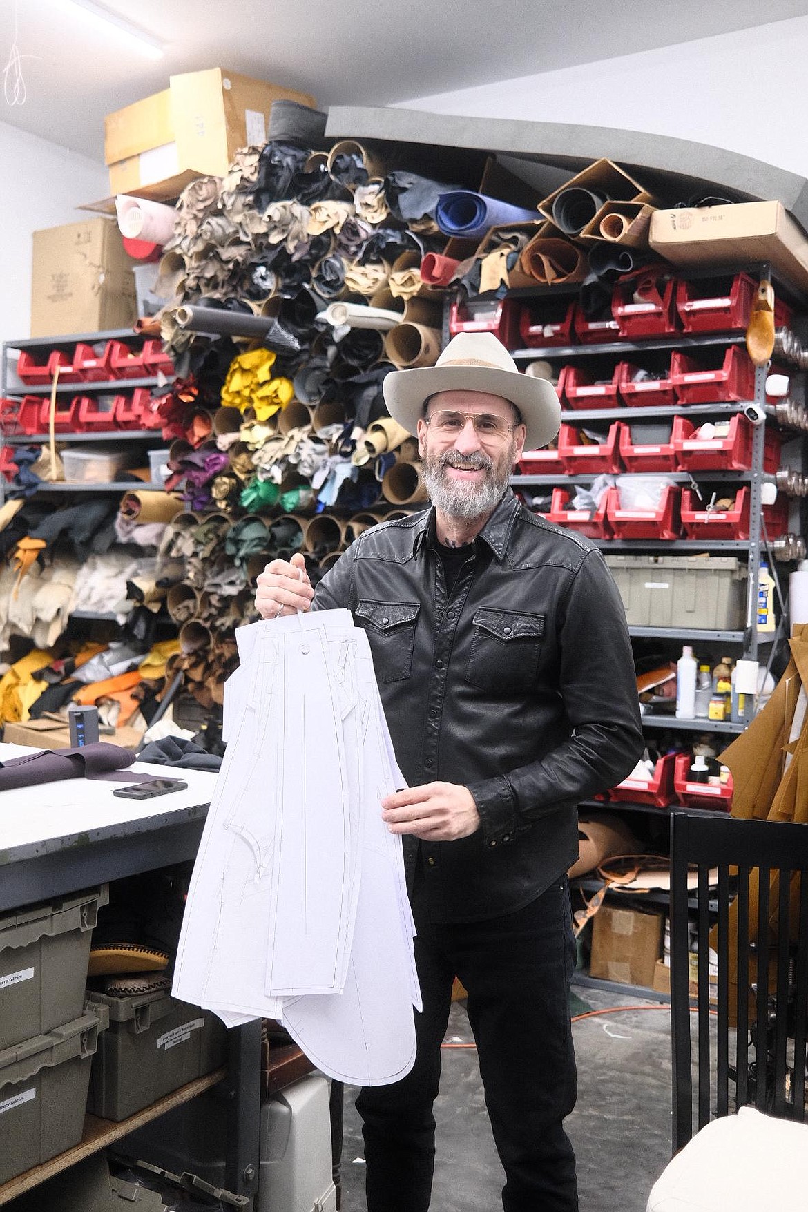 Master tailor Milen Krastev poses in his Whitefish studio. Krastev and his wife are the team behind MAD Leather, which designs and creates custom leather boots, jackets and more. (Adrian Knowler/Daily Inter Lake)