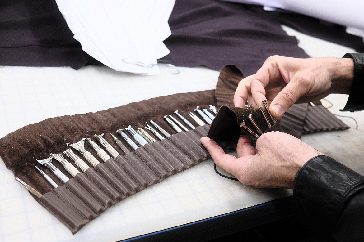 Milen Krastev selects a leather stamping tool from his collection at his studio in Whitefish. (Adrian Knowler/Daily Inter Lake)