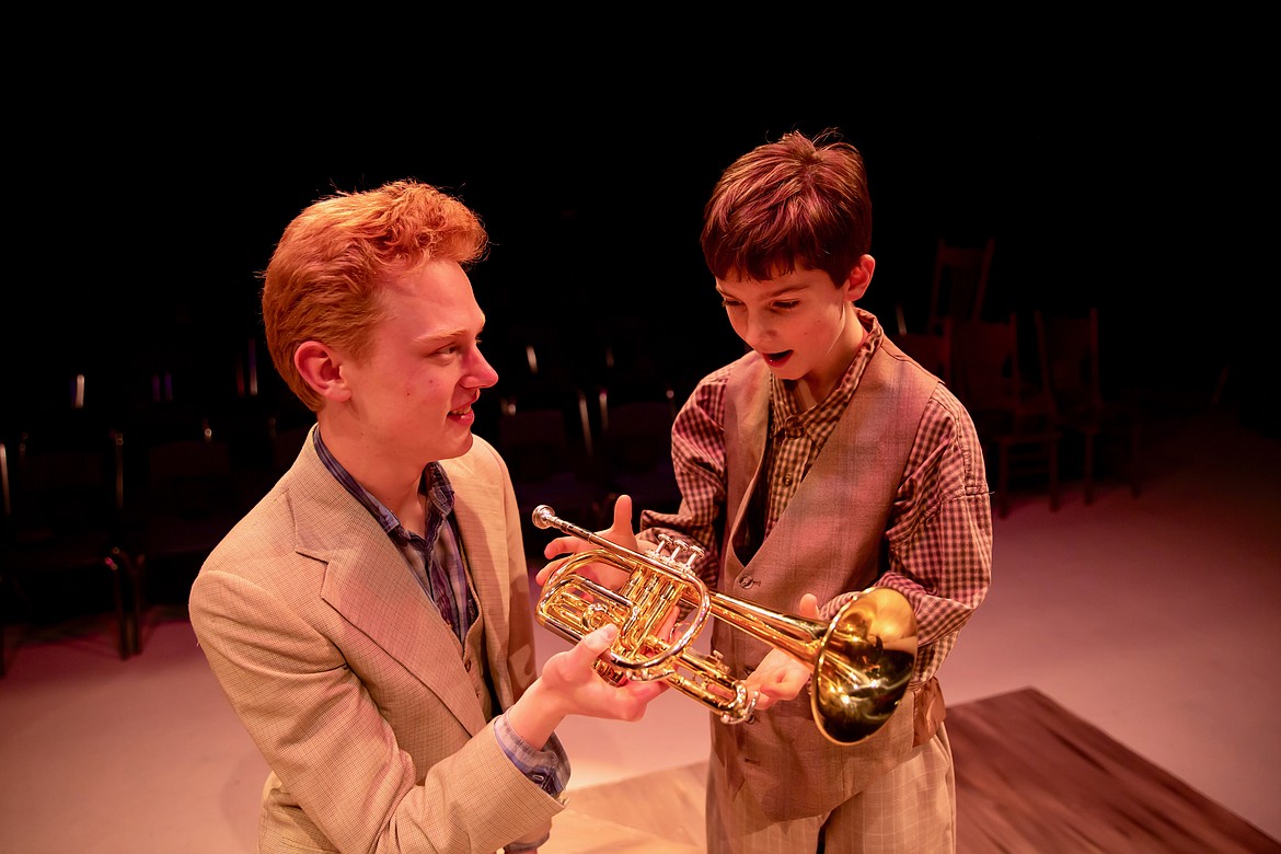 Alden Lamson, as Harold Hill, presents Winthrop, played by Bosley Wakefield, with his gold cornet during the Wolfpack Theatre Company’s production of “The Music Man.” (Courtesy photo)
