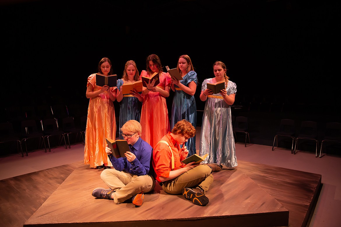 Students of River City, including Anya Rountree, Ellie Knuffke, Ella Halliburton, Isabelle McKoy and Alyssa Conrad, gather in Marian's library to read books in the Wolfpack Theatre Company’s production of “The Music Man.” (Courtesy photo)