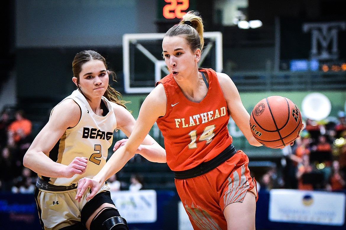 Flathead's Kennedy Moore (14) drives to the basket against Billings West's Kourtney Grossman (2) in the first half of the girls' Class AA state basketball championship at the Butte Civic Center on Saturday, March 11. (Casey Kreider/Daily Inter Lake)