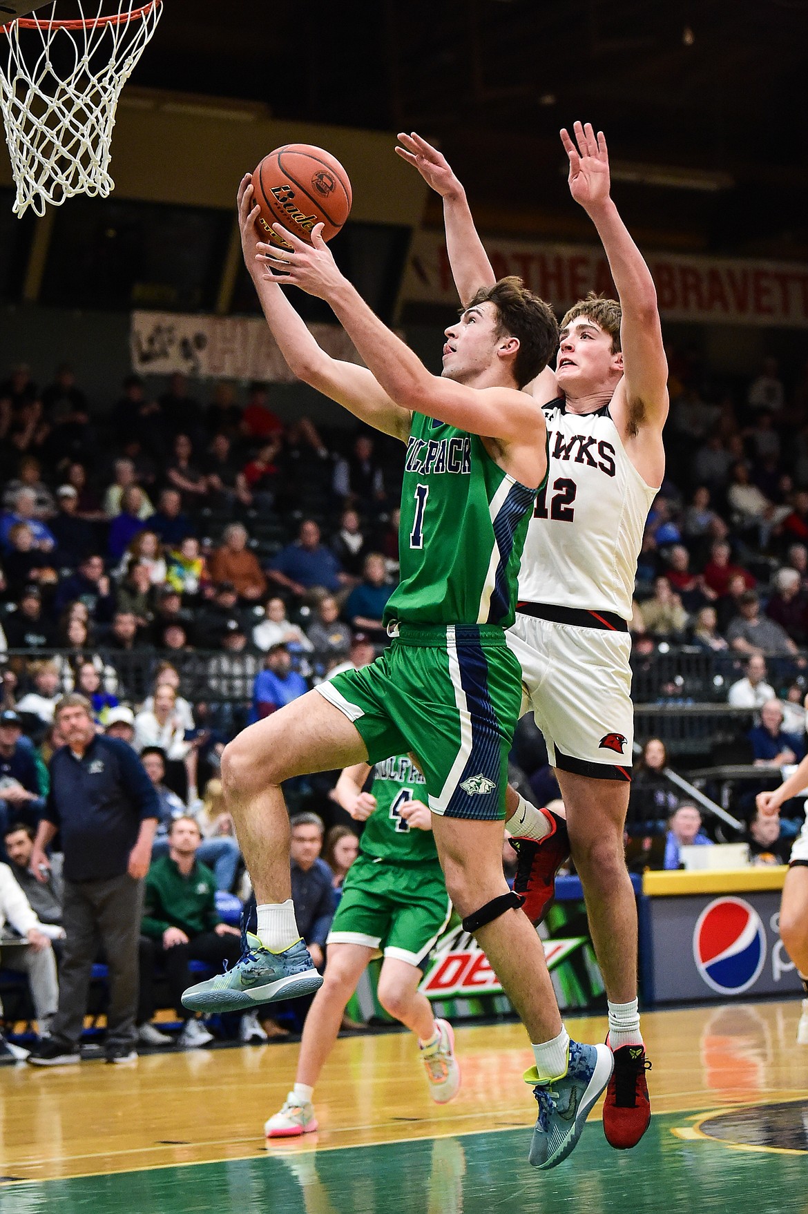 Glacier's Cohen Kastelitz (1) drives to the basket against Bozeman's Rocky Lencioni (12) in the second half of the third-place game at the Class AA state basketball tournament at the Butte Civic Center on Saturday, March 11. (Casey Kreider/Daily Inter Lake)