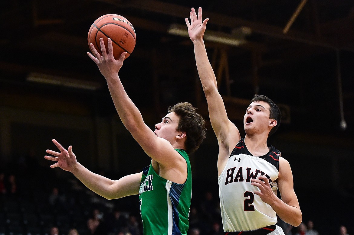 Glacier's Ty Olsen (5) drives to the basket past Bozeman's Kellen Harrison (2) in the first half of the third-place game at the Class AA state basketball tournament at the Butte Civic Center on Saturday, March 11. (Casey Kreider/Daily Inter Lake)