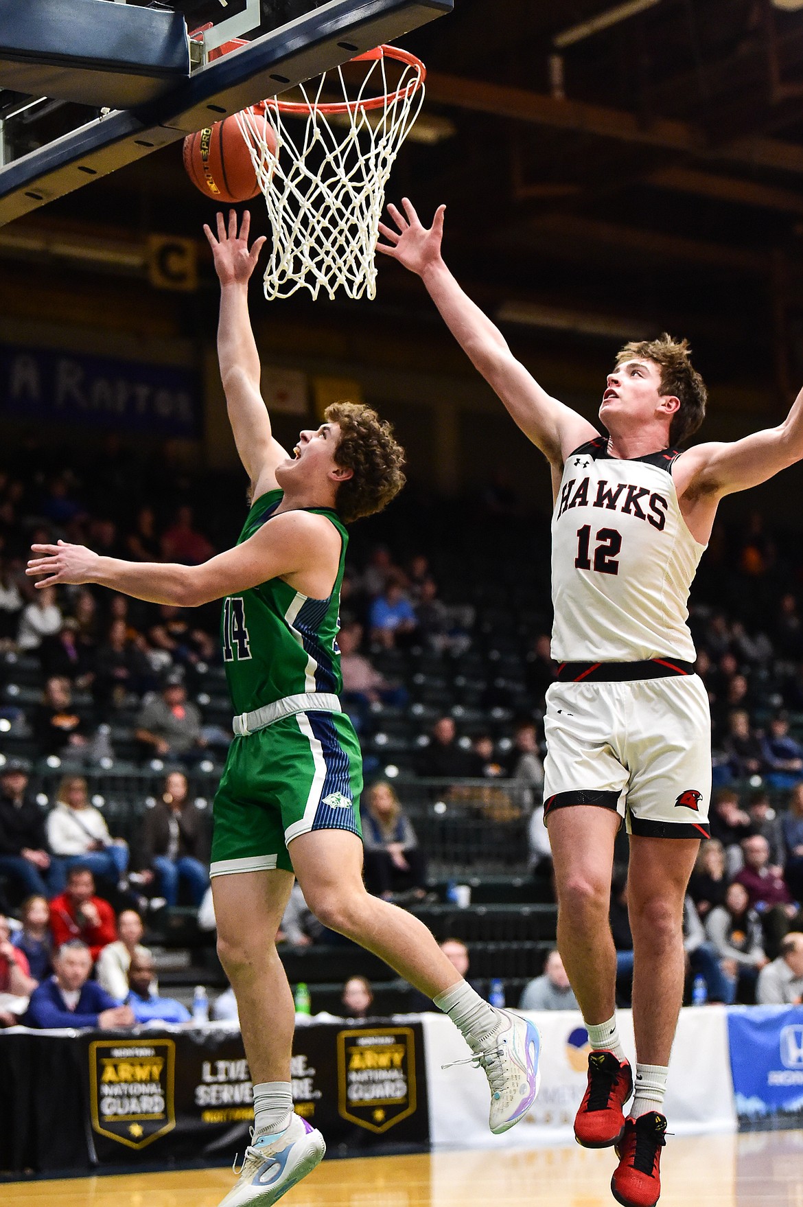 Glacier's Kaidrian Buls (14) drives to the basket past Bozeman's Rocky Lencioni (12) in the first half of the third-place game at the Class AA state basketball tournament at the Butte Civic Center on Saturday, March 11. (Casey Kreider/Daily Inter Lake)