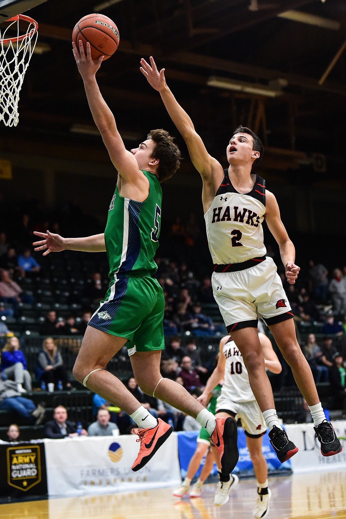 Glacier's Ty Olsen (5) drives to the basket past Bozeman's Kellen Harrison (2) in the first half of the third-place game at the Class AA state basketball tournament at the Butte Civic Center on Saturday, March 11. (Casey Kreider/Daily Inter Lake)