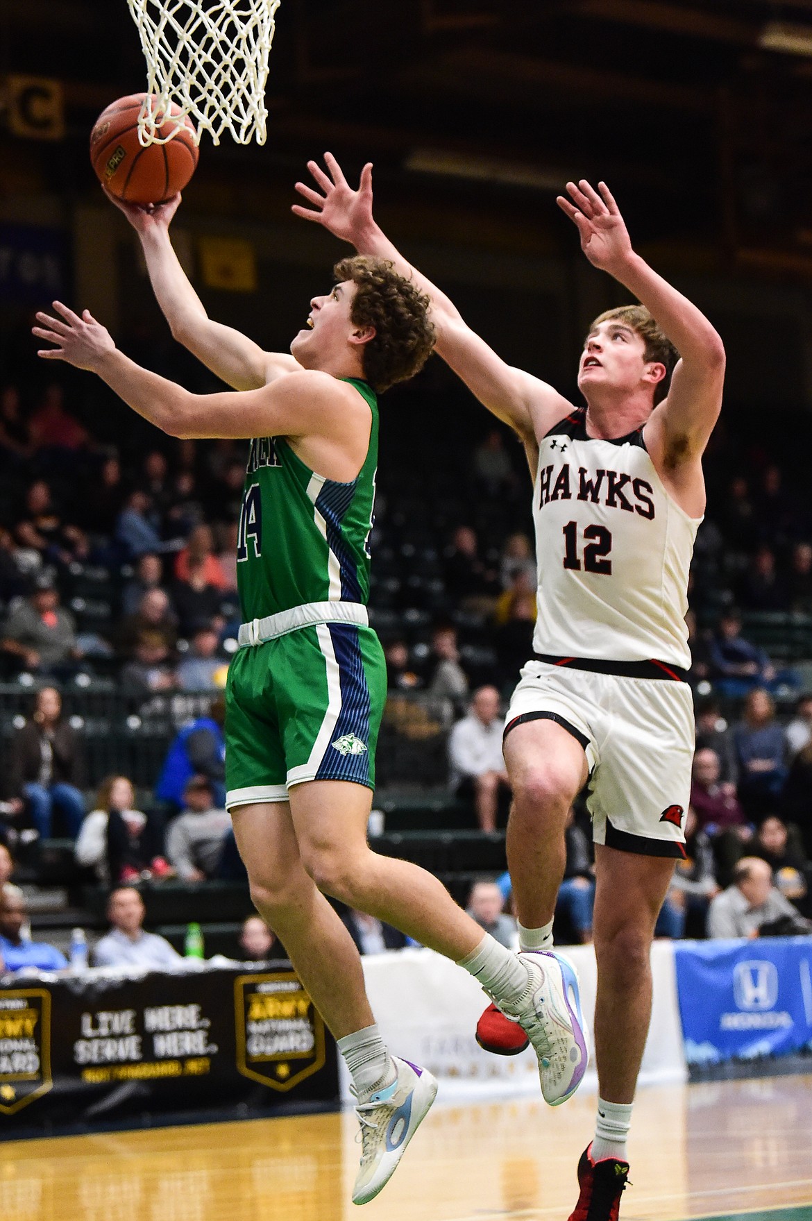 Glacier's Kaidrian Buls (14) drives to the basket past Bozeman's Rocky Lencioni (12) in the first half of the third-place game at the Class AA state basketball tournament at the Butte Civic Center on Saturday, March 11. (Casey Kreider/Daily Inter Lake)