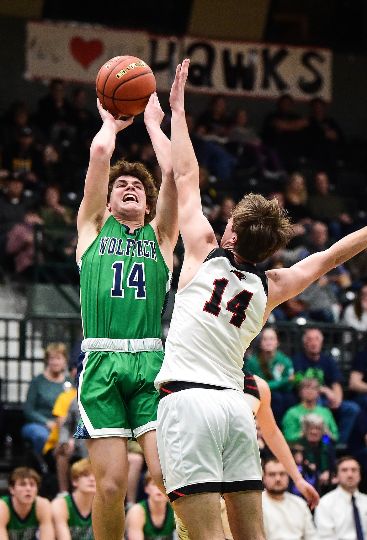 Glacier's Kaidrian Buls (14) shoots over Bozeman's Chapman Wiehardt (14) in the second half of the third-place game at the Class AA state basketball tournament at the Butte Civic Center on Saturday, March 11. (Casey Kreider/Daily Inter Lake)