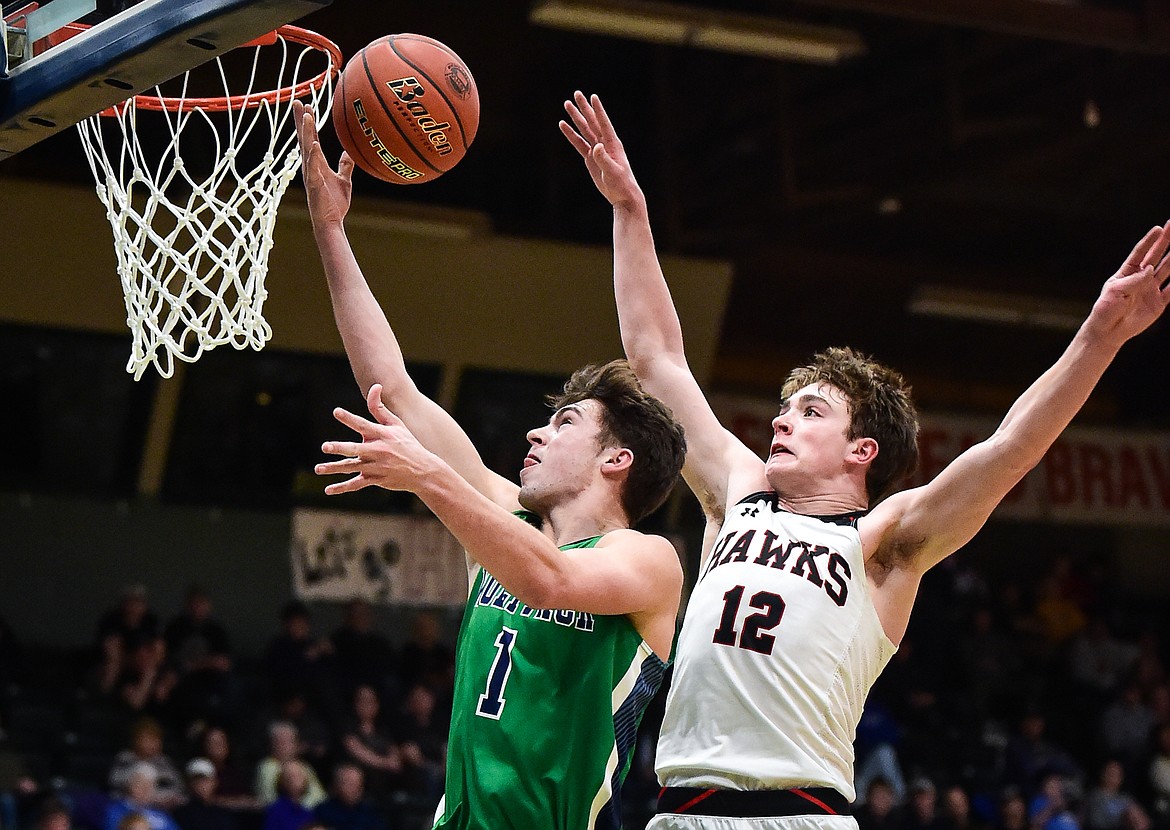 Glacier's Cohen Kastelitz (1) drives to the basket against Bozeman's Rocky Lencioni (12) in the second half of the third-place game at the Class AA state basketball tournament at the Butte Civic Center on Saturday, March 11. (Casey Kreider/Daily Inter Lake)