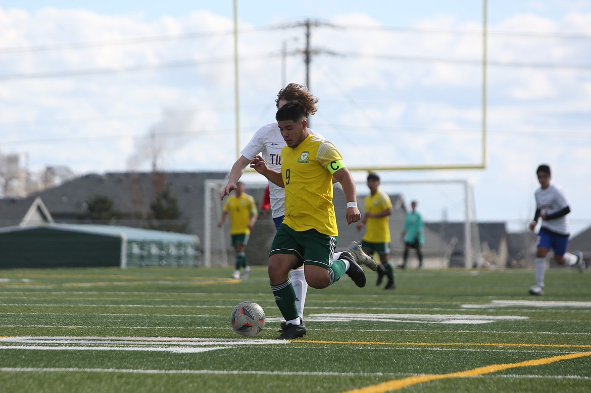 Quincy senior Jorge Nunez (9) races past a Tonasket defender in the second half of the Jackrabbits’ 10-0 win on Saturday.