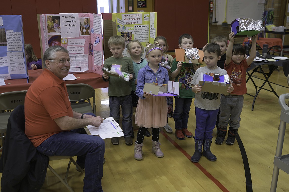 Noxon School Board Chair Dave Pafford judges projects at the Noxon science fair. (Tracy Scott/Valley Press)