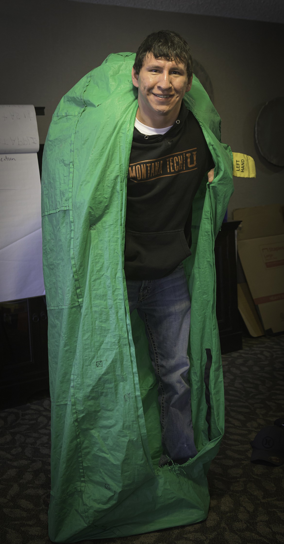 Keith Good Gun demonstrates the deployment of a personal fire shelter. (Tracy Scott/Valley Press)