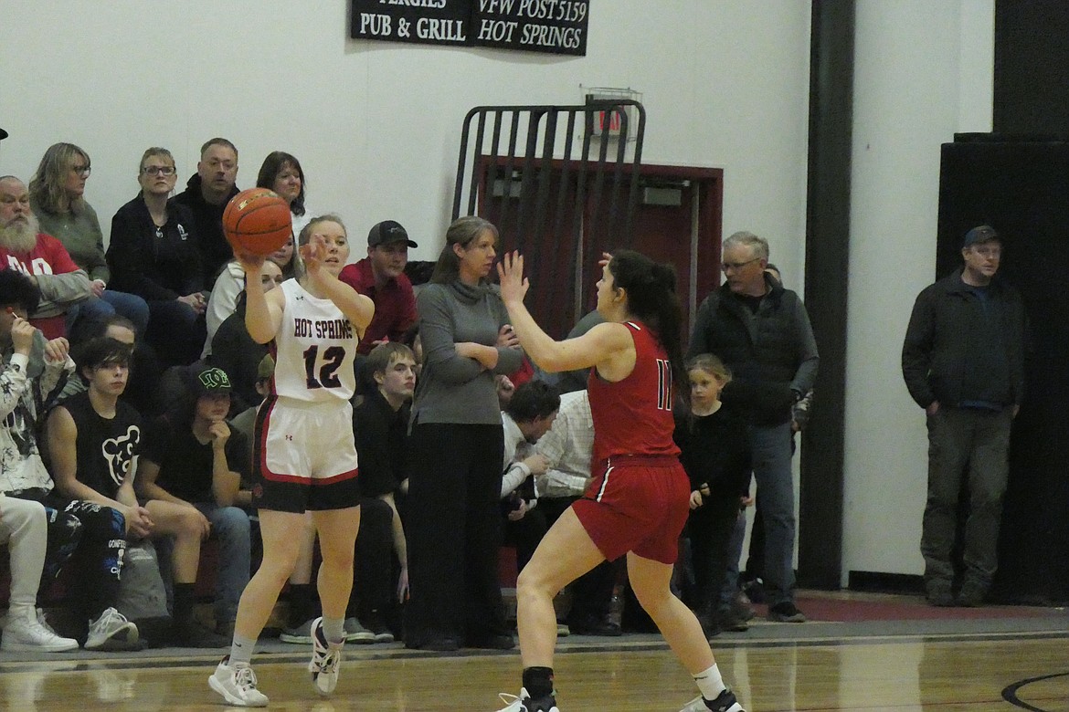 Noxon all-State and all-District first team selection Emily Brown (red uniform, 11) guard's an in-bound pass attempt from Hot Springs second team district pick Josie Uski (12) during a game earlier this season. (Chuck Bandel/VP-MI)