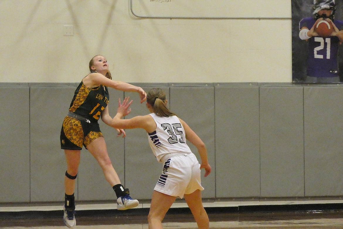 St. Regis first team District 14C selection Macy Hill throws a pass around a Charlo player during a game earlier this year. (Chuck Bandel/MI-VP)