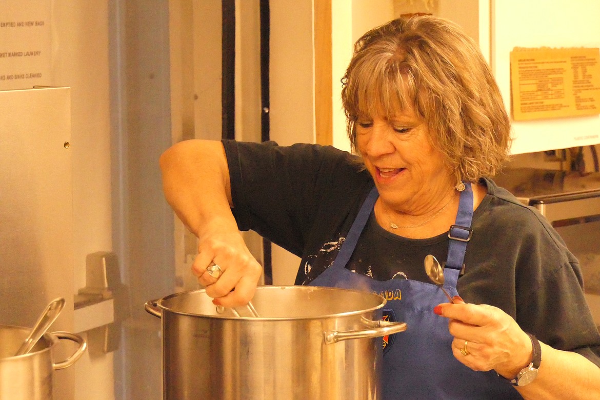 VFW Auxiliary volunteer cook Linda Barnes stirs a large pot of sausage gravy during meal preparation Saturday morning for the once a month Biscuits and Gravy breakfast at the Plains VFW meeting hall. (Chuck Bandel/VP-MI)