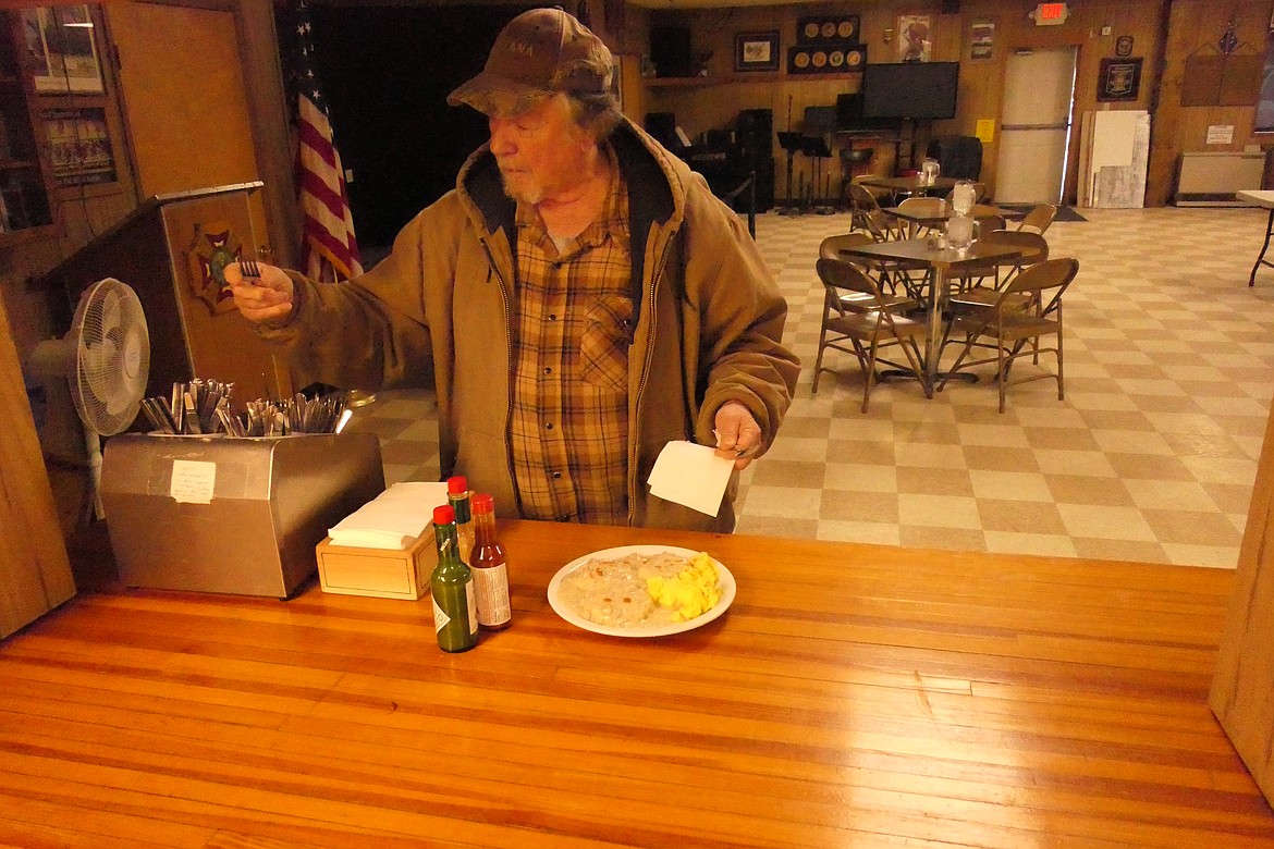 Plains area veteran Dan Johnson puts the finishing touches on his biscuits and gravy breakfast during the VFW Auxiliary's monthly biscuits and gravy breakfast Saturday at the Plains VFW. (Chuck Bandel/VP-MI)