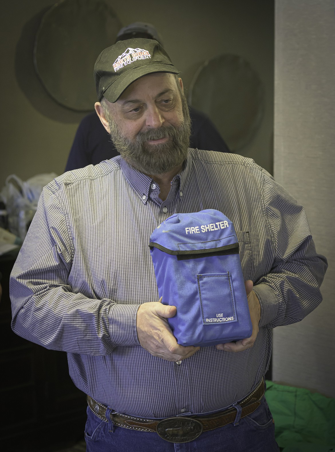 Richard Grady, owner Grady Bunch LLC, shows off a counterfeit personal fire shelter that is reportedly being sold in Montana. (Tracy Scott/Valley Press)