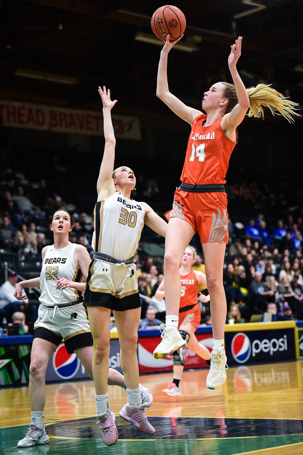 Flathead's Kennedy Moore (14) drives into the lane against Billings West's Ellie Stock (30) in the second half of the girls' Class AA state basketball championship at the Butte Civic Center on Saturday, March 11. (Casey Kreider/Daily Inter Lake)