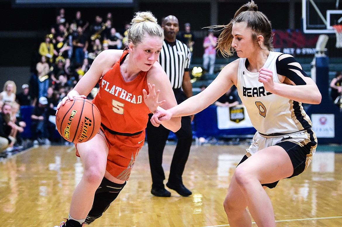 Flathead's Maddy Moy (5) drives to the basket against Billings West's Layla Baumann (0) in the second half of the girls' Class AA state basketball championship at the Butte Civic Center on Saturday, March 11. (Casey Kreider/Daily Inter Lake)