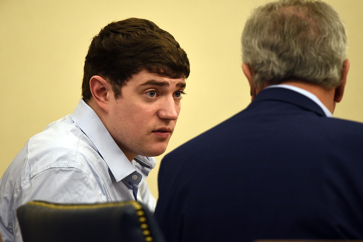 Zackary Matthew Maas speaks with his attorney, Stephen Nardi, during the opening day of his deliberate homicide jury trial in Flathead County District Court. (Derrick Perkins/Daily Inter Lake)