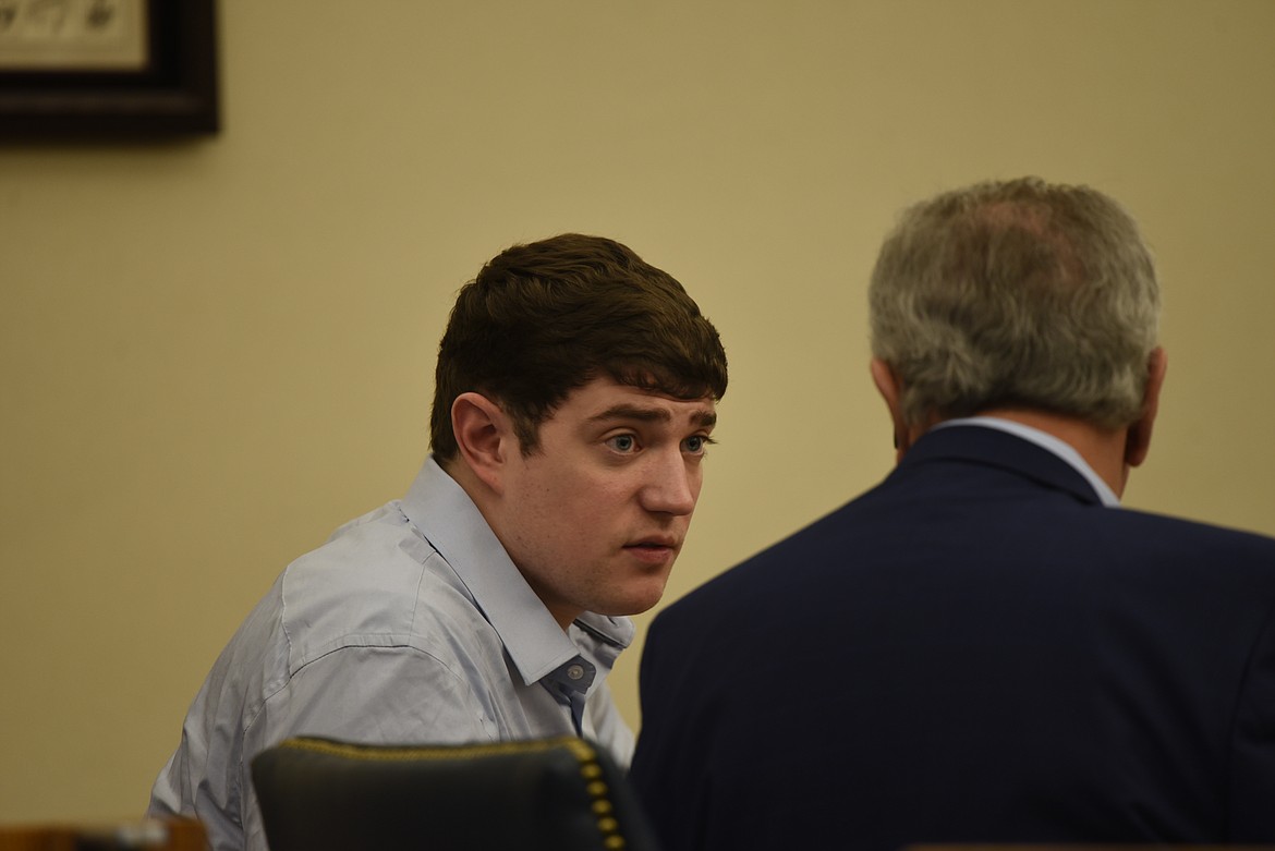 Zackary Matthew Maas speaks with his attorney, Stephen Nardi, during the opening day of his deliberate homicide jury trial in Flathead County District Court. (Derrick Perkins/Daily Inter Lake)