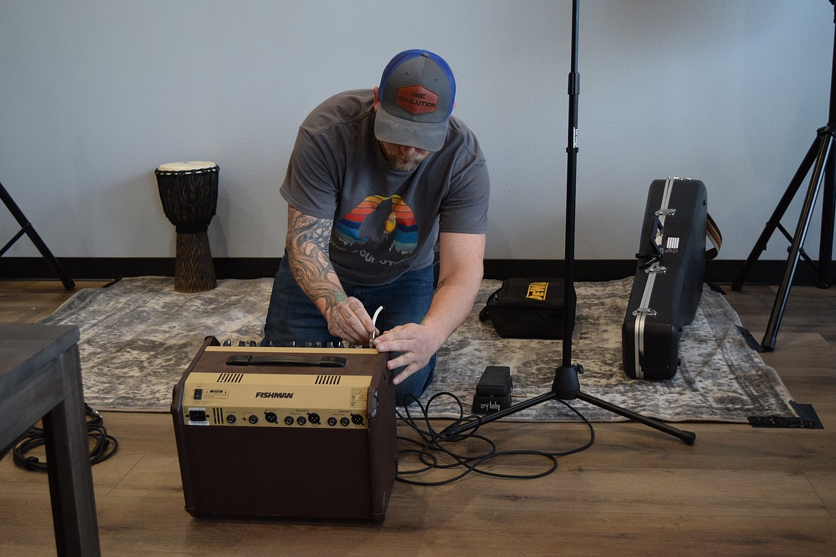 L.J. Polmateer sets up his monitor amp as he gets ready to perform at the Moses Lake Taproom during the taproom’s opening weekend in early March.