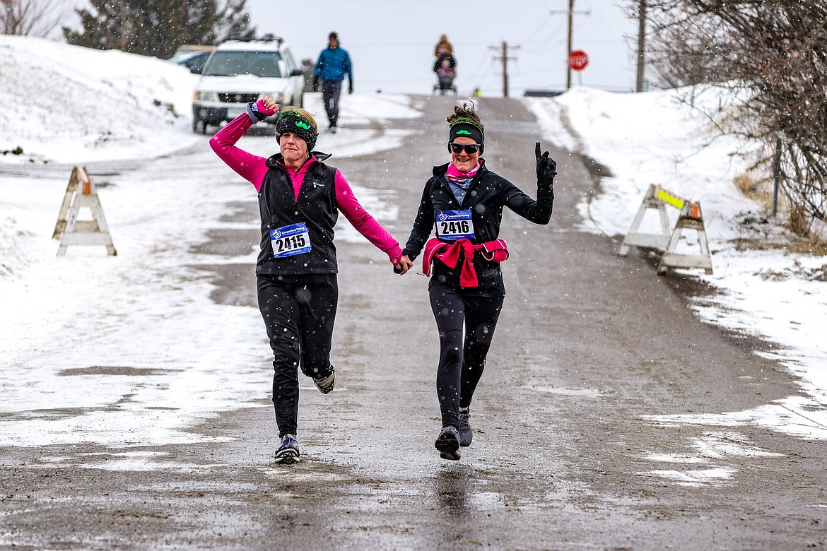 Sara Hammel and Sheila Murphy of Eureka cross the finish line of the Cloverfest 5k on Saturday. (JP Edge photo)