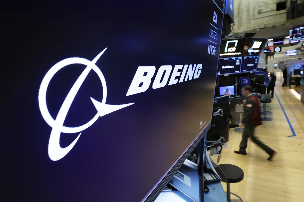 In this March 11, 2019 file photo, the Boeing logo appears above a trading post on the floor of the New York Stock Exchange. Saudi Arabia is buying up to 121 jetliners from Boeing in a big boost for the American manufacturer. The deal was expected to be announced Tuesday, March 14, 2023. (AP Photo/Richard Drew, File)