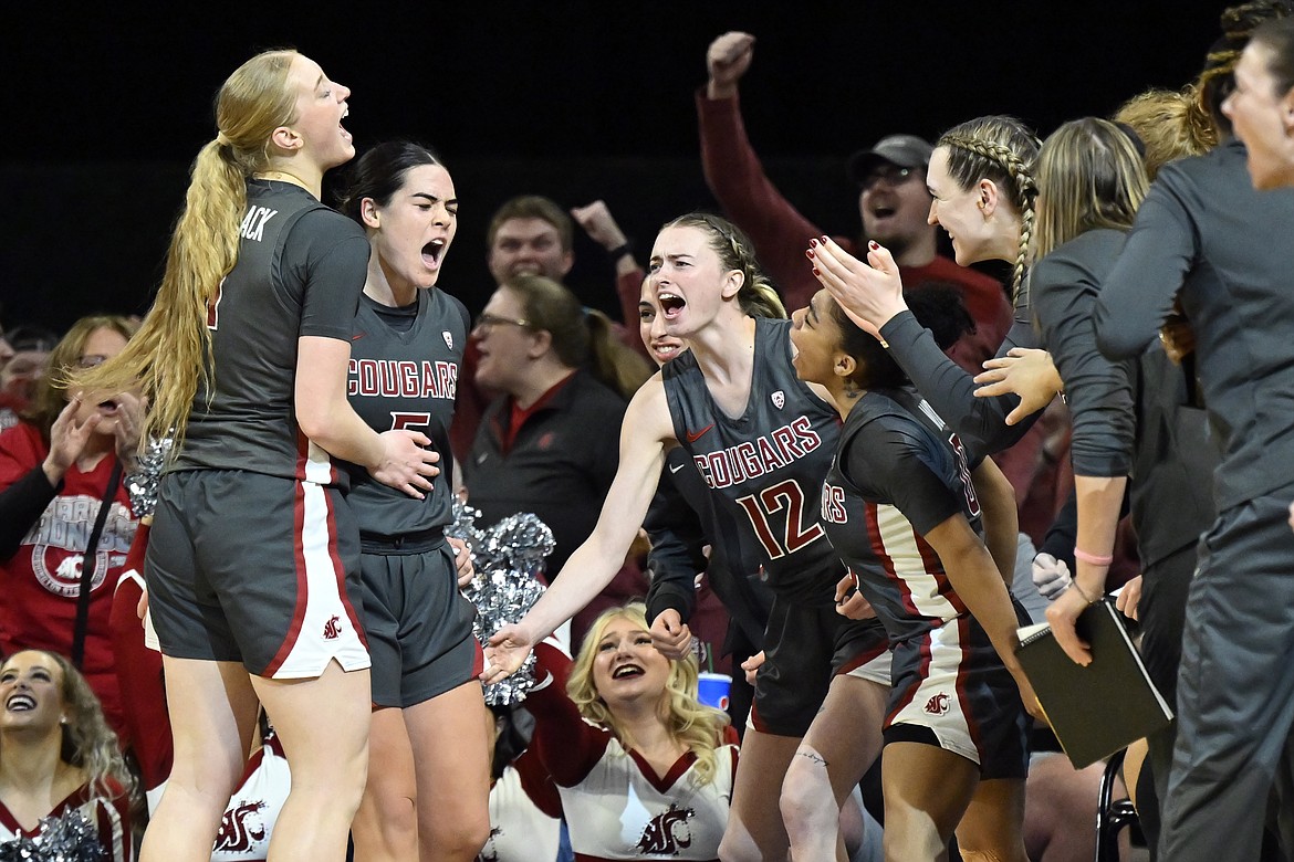 The WSU Cougars celebrate after a three-pointer by Charlisse Leger-Walker, second from left, in the Pac-12 Tournament championship game on March 5. Leger-Walker leads the Cougars with 18.1 points per game.