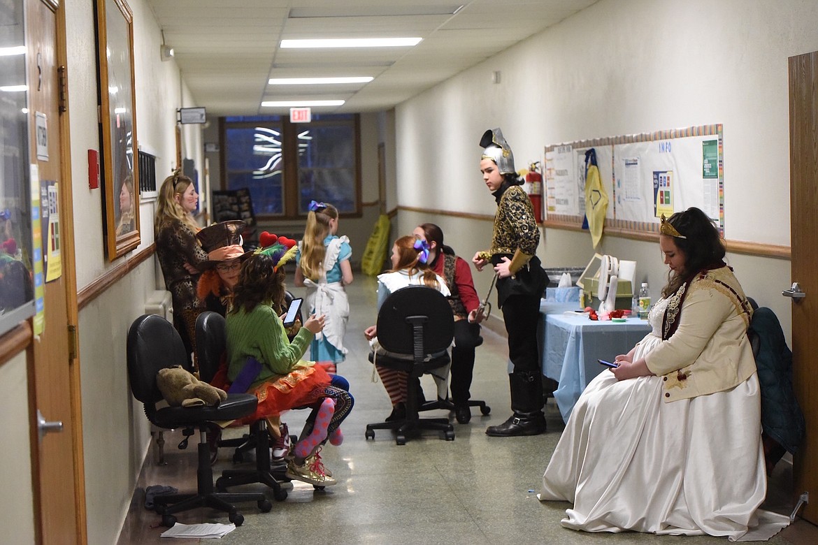 Members of the Pitiful Players cast of 'Alice in Wonderland' wait for the curtain to raise at the Maki Theatre on Saturday, March 11. (Scott Shindledecker/The Western News)