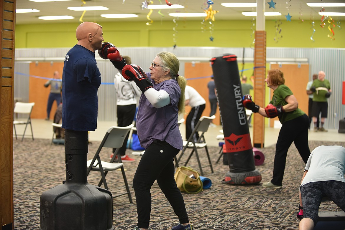 Lela Newey boxes a freestanding body opponent bag during the Rock Steady Boxing — Glacier class for people with Parkinson's on Monday, March 13, 2023, at Gateway Community Center in Kalispell. (Hilary Matheson/Daily Inter Lake)