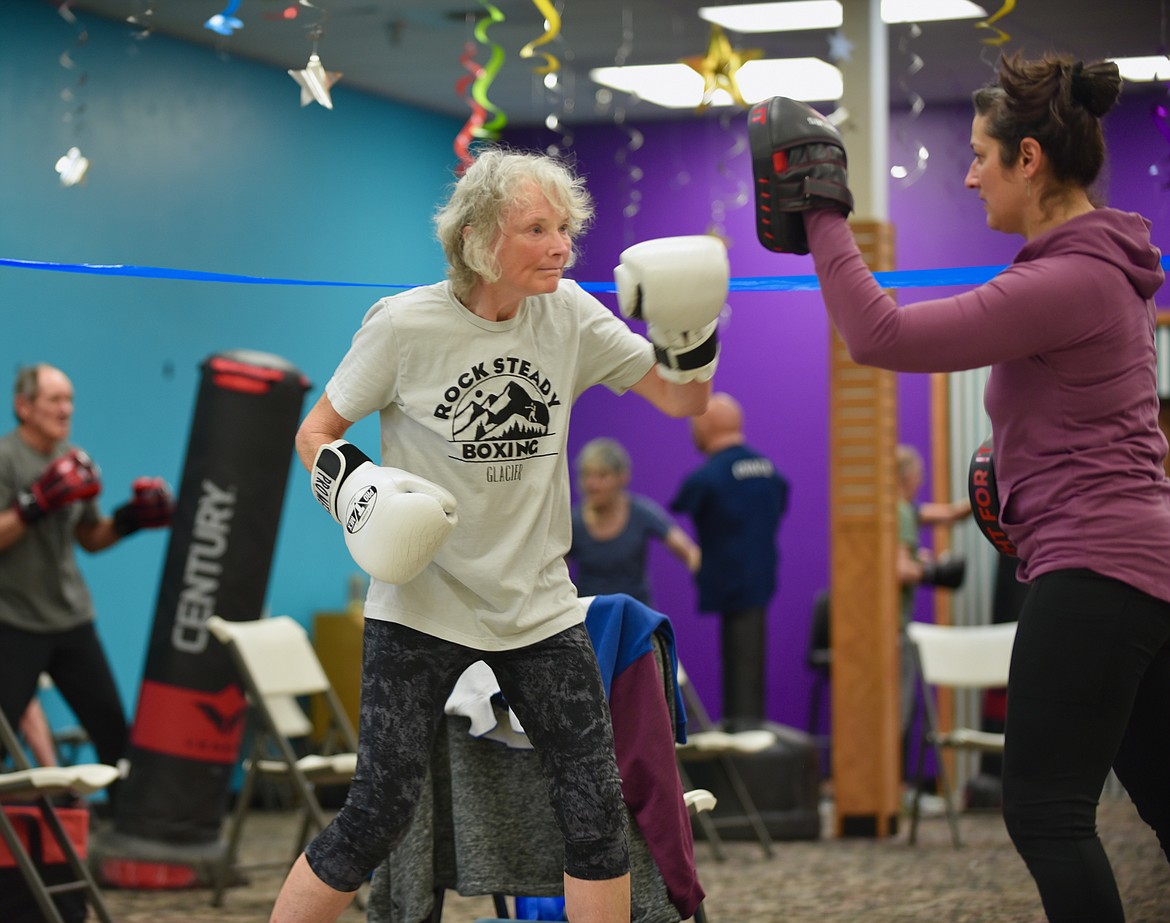Marjory McClaren practices her punching technique with assistant coach Loretta Merriman, during a Rock Steady Boxing — Glacier class on Monday, March, 13, 2023, at Gateway Community Center in Kalispell. The no-contact boxing-based fitness program helps people with Parkinson's disease work on eye-hand coordination and movement. (Hilary Matheson/Daily Inter Lake)