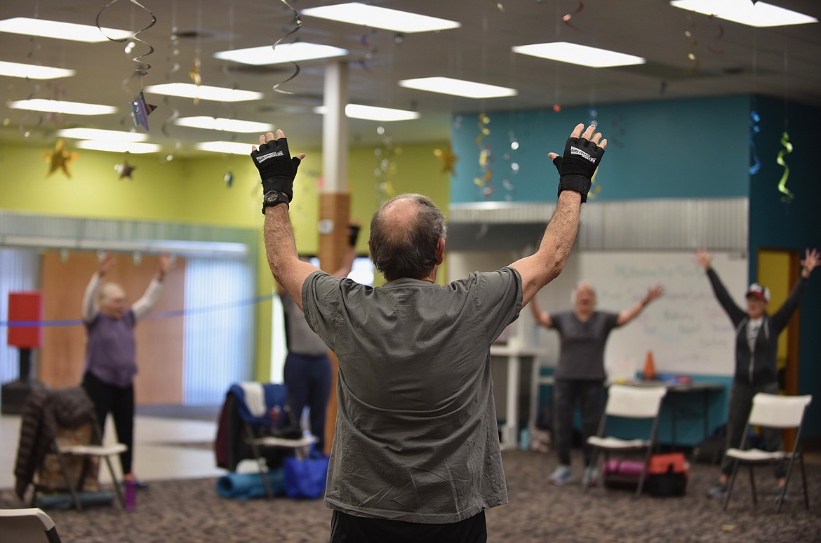 Participants stretch during a no-contact boxing-based fitness class called Rock Steady Boxing on Monday, March 13, 2023, at Gateway Community Center in Kalispell. (Hilary Matheson/Daily Inter Lake)