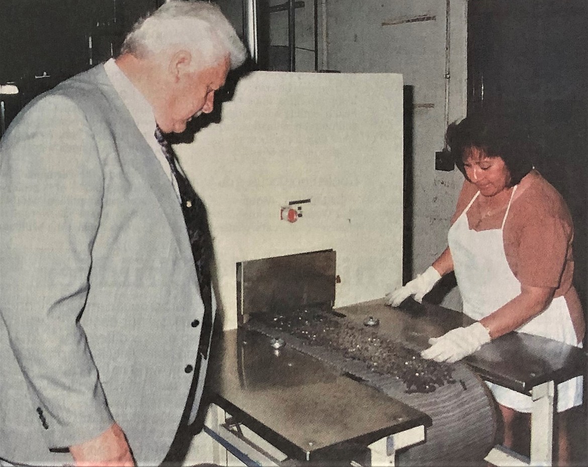 Buck Knives Chairman Chuck Buck inspects knives.