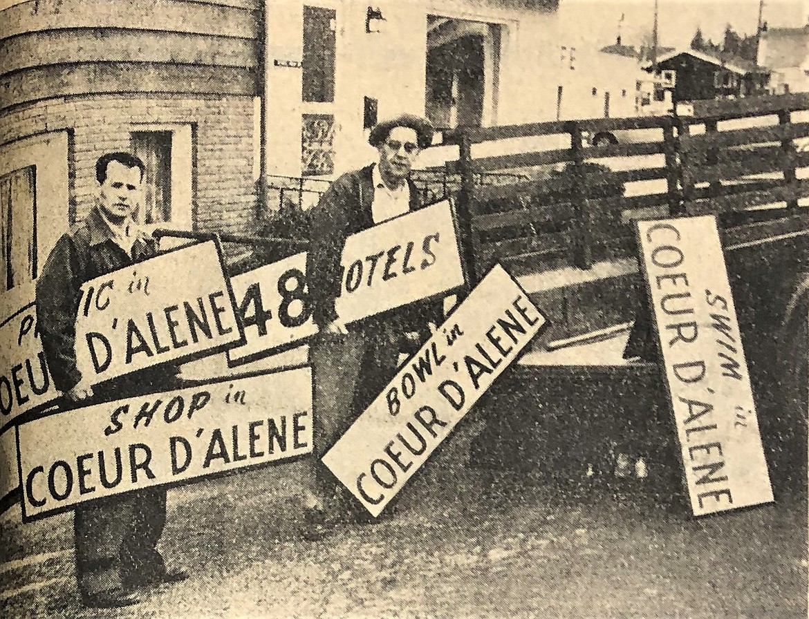 Lyle McDonald, left, and Harold Lines of the Coeur d’Alene Motel Association prepare to take Coeur d’Alene tourism signs to Cheney, Wash.