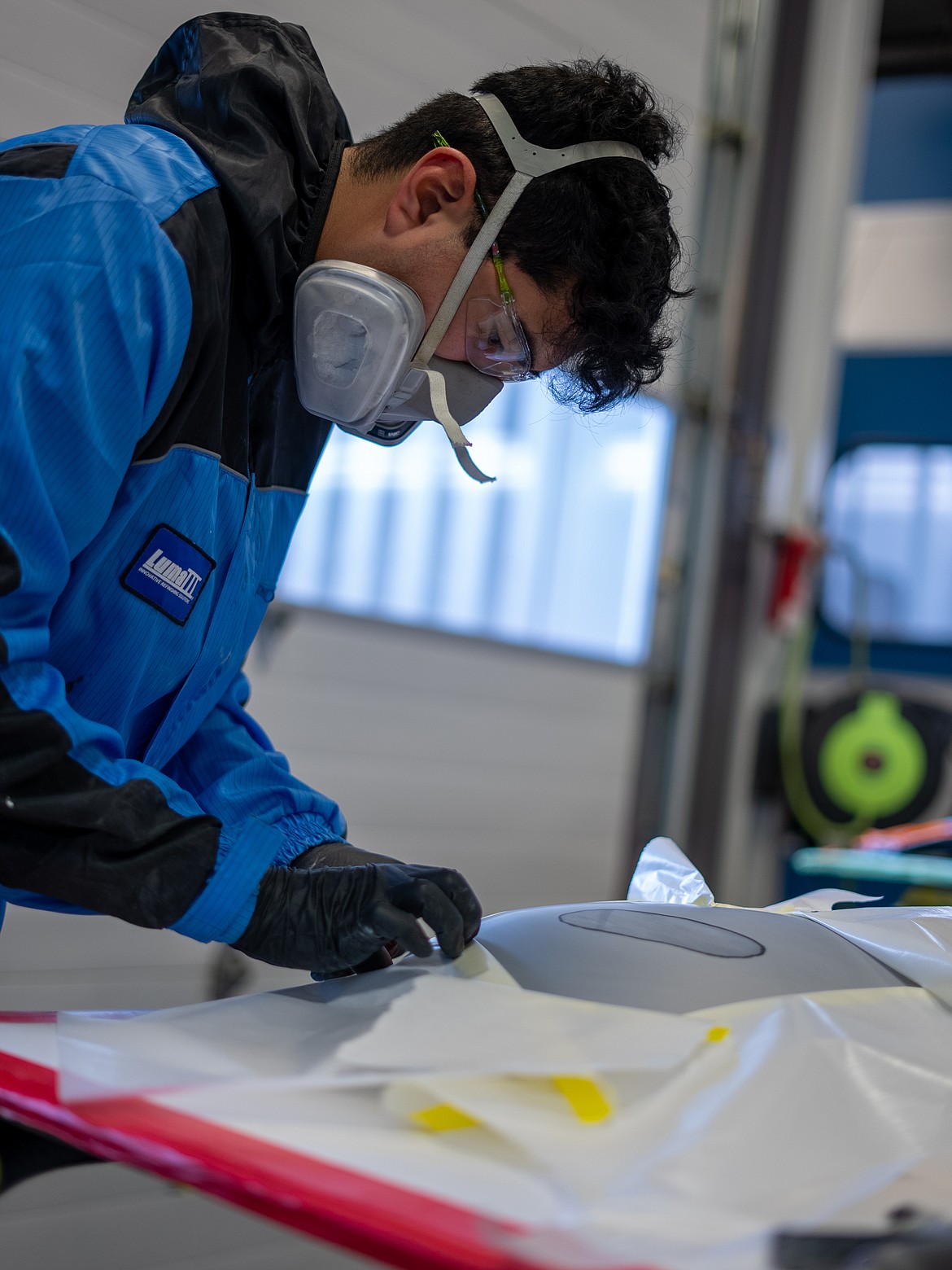 NIC student Isaac Carder of Hayden works on his auto refinishing entry in North Idaho College’s auto collision repair competition Friday, March 10 at NIC’s Parker Technical Education Center in Rathdrum.